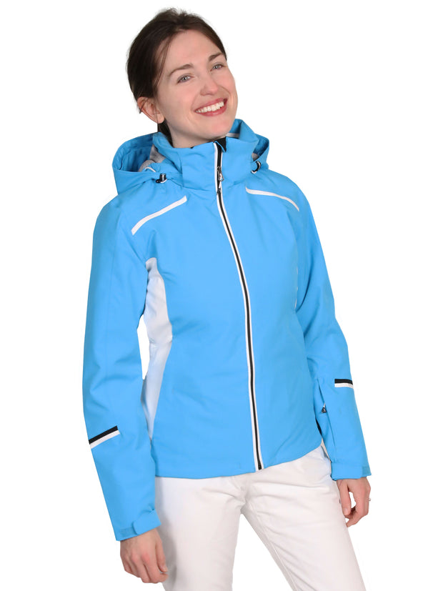 A woman wearing a blue insulated jacket with a hood, featuring white and black accents with zippered pockets.